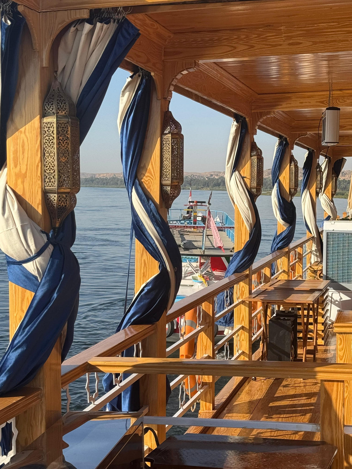 Elegant Dahabeyya boat on the Nile river with clear skies, showcasing a classic Egyptian cruise on the Nile during an Easter tour.